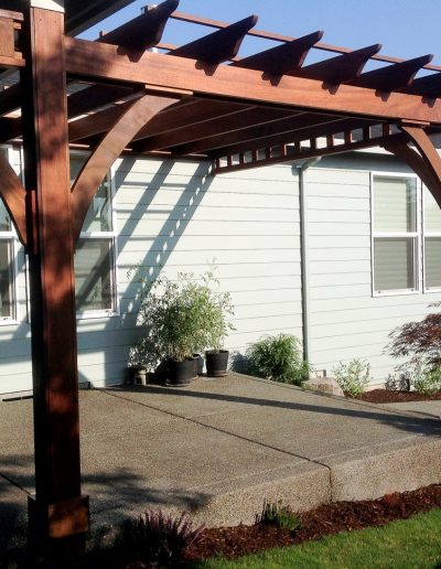 A Greenhaven Landscapes design customer's Vancouver WA wood arbor over concrete patio