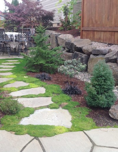 A Greenhaven Landscapes design customer's Vancouver WA backyard stone patio and walkways with stone retaining wall