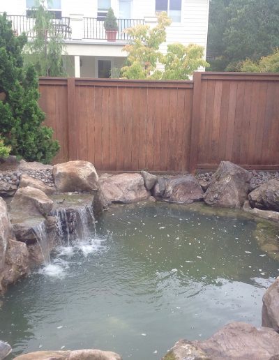 A Greenhaven Landscapes design customer's Vancouver WA large pond with stone walls and waterfall water feature