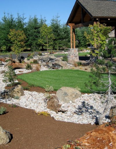 A Greenhaven Landscapes-designed customer's Vancouver WA full landscaping with lush grass, stone features, and log