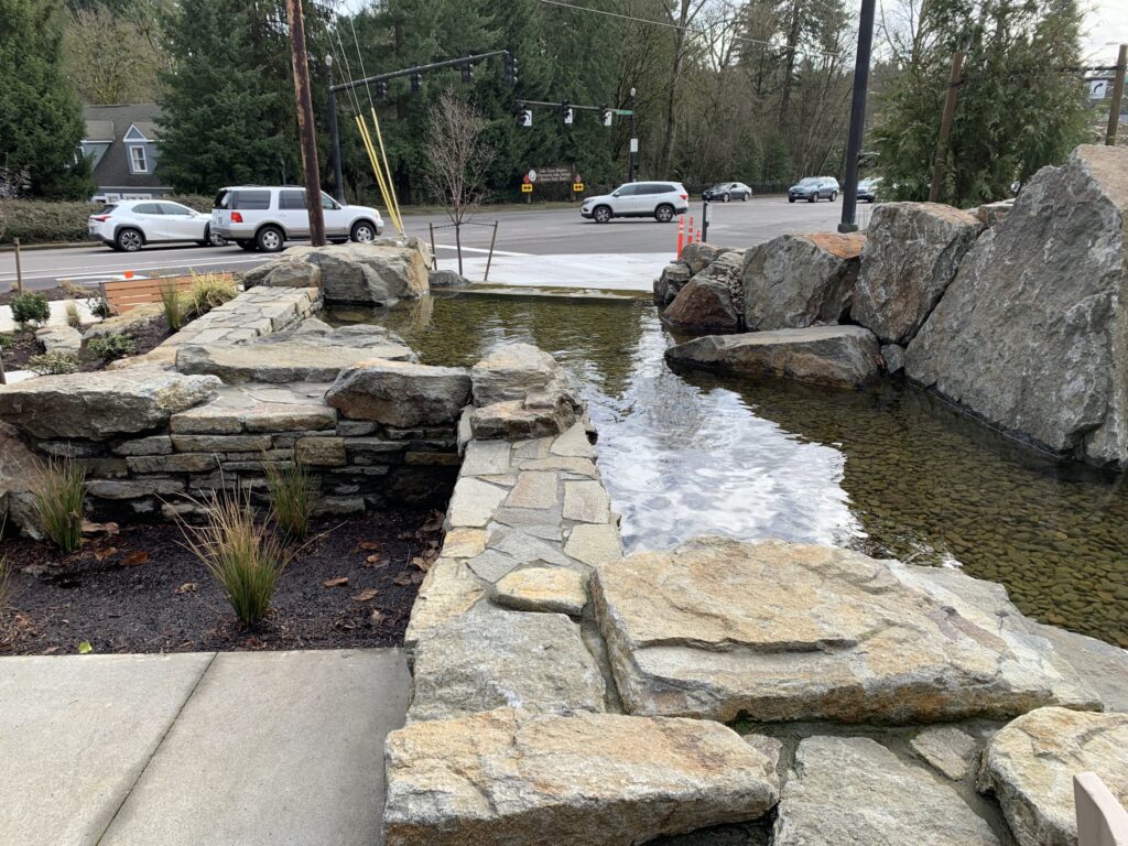 Rock walls and pond area looking out toward the road in Lake Oswego at The Springs
