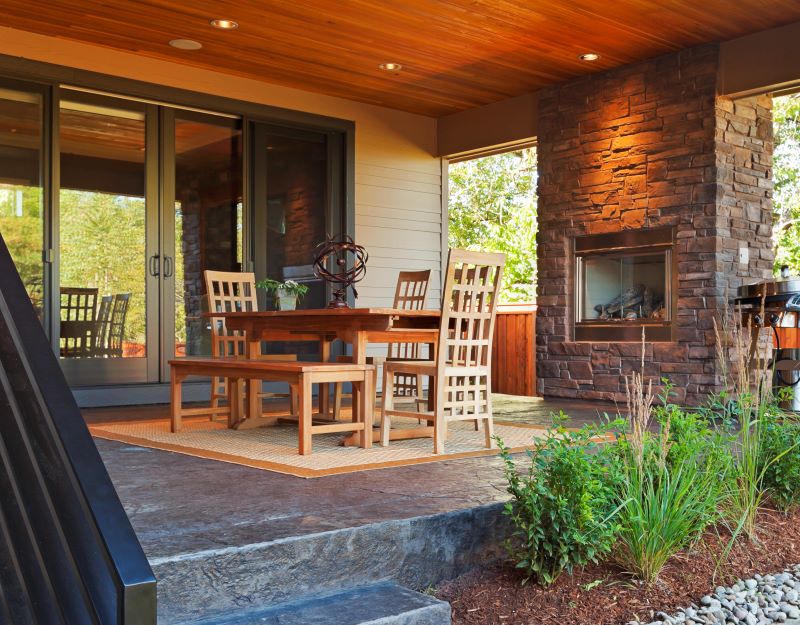 Greenhaven covered patio with stone outdoor fireplace