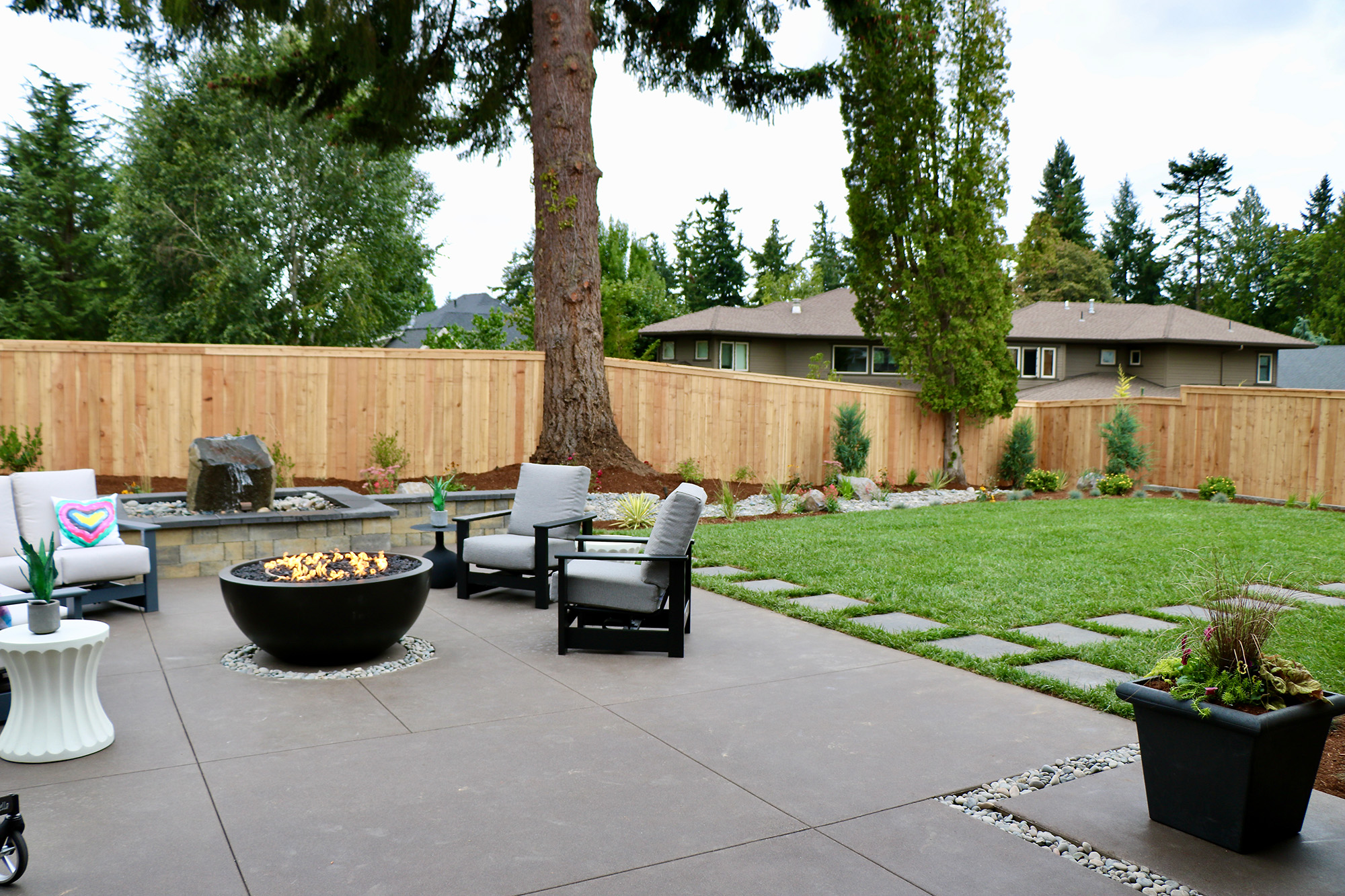 patio with raised fire pit by Greenhaven Landscapes