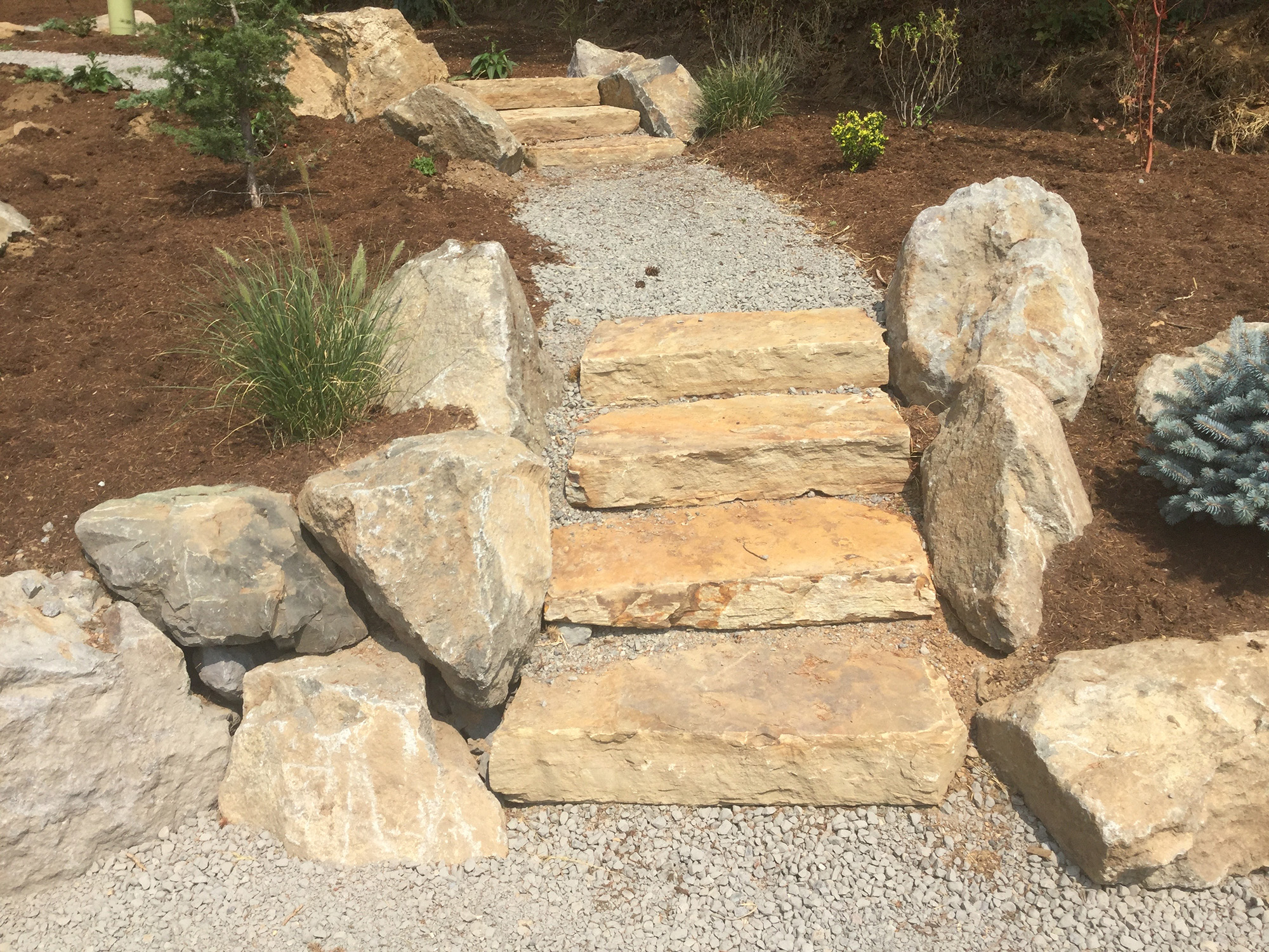 stone steps and gravel walkway by Greenhaven Landscapes
