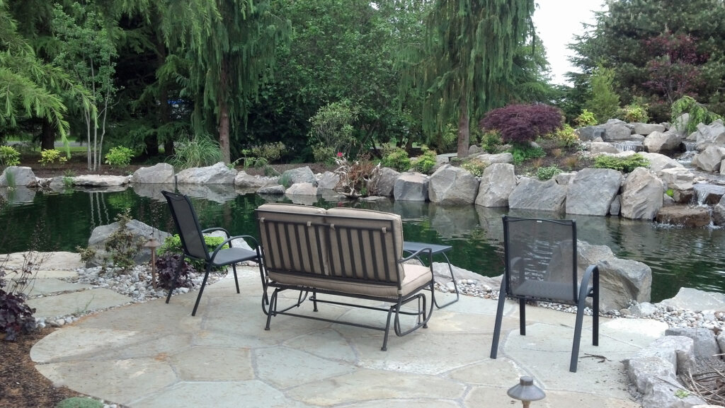 water feature flowing into large pond by Greenhaven Landscapes