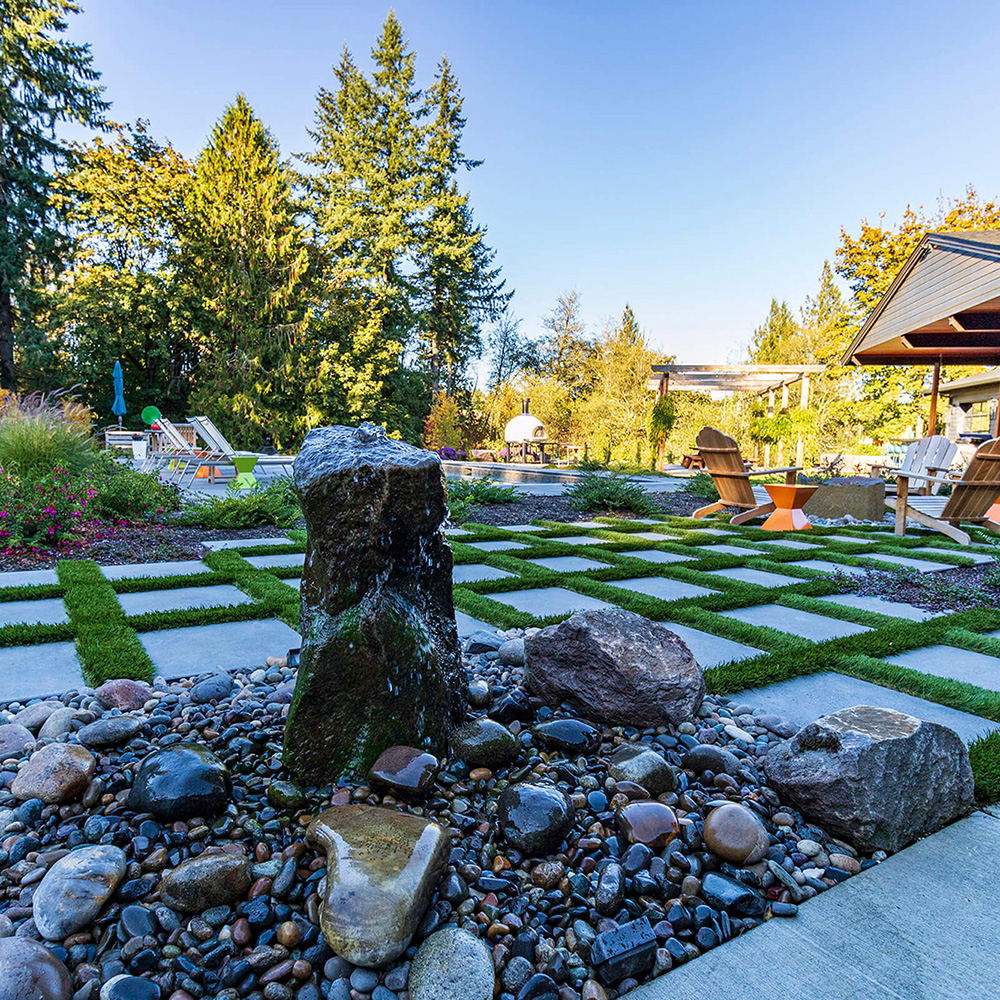 water feature in front of square grid lawn by Greenhaven Landscapes