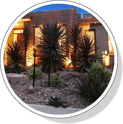 a home with up lighting by Greenhaven Landscapes