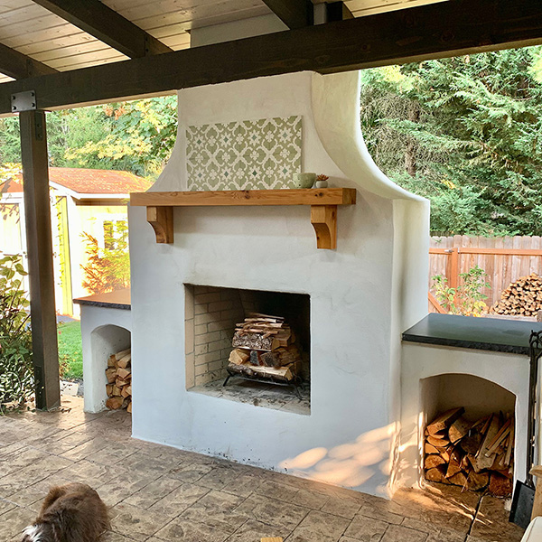 outdoor living space by Greenhaven Landscapes with fireplace