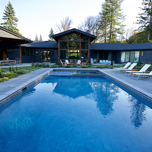 a pool with inset hot tub by Greenhaven Landscapes