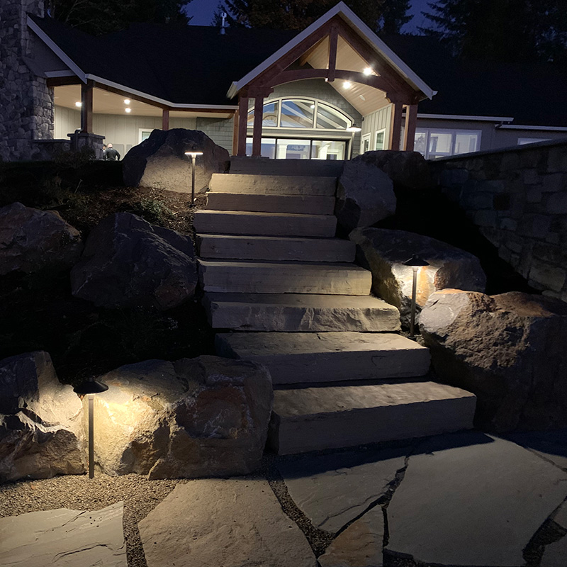 outdoor lighting illuminating a path at night by Greenhaven Outdoor Living