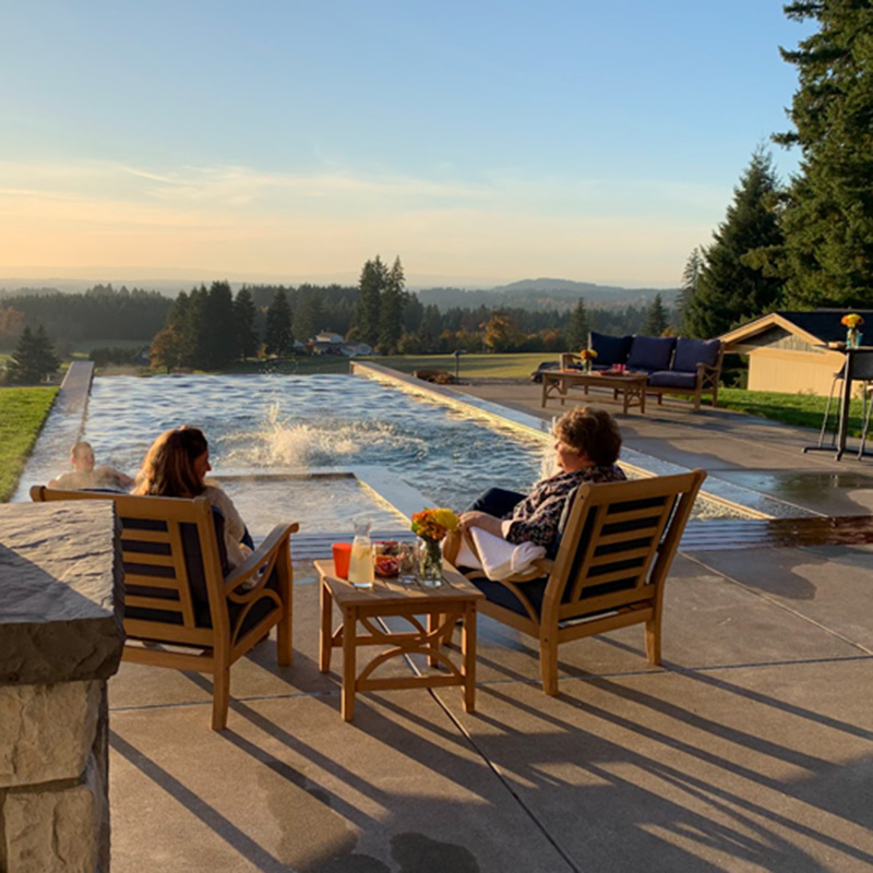 a family enjoying their backyard retreat custom pool from Greenhaven Outdoor Living
