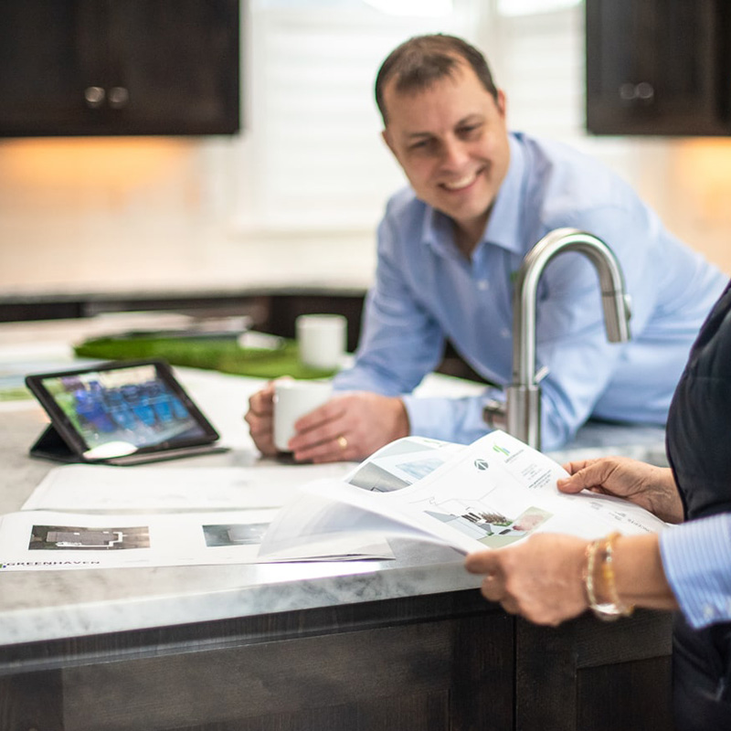 members of the Greenhaven Landscapes laugh while planning a new project