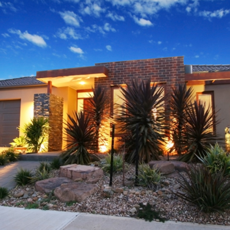 a home with up lighting by Greenhaven Outdoor Living