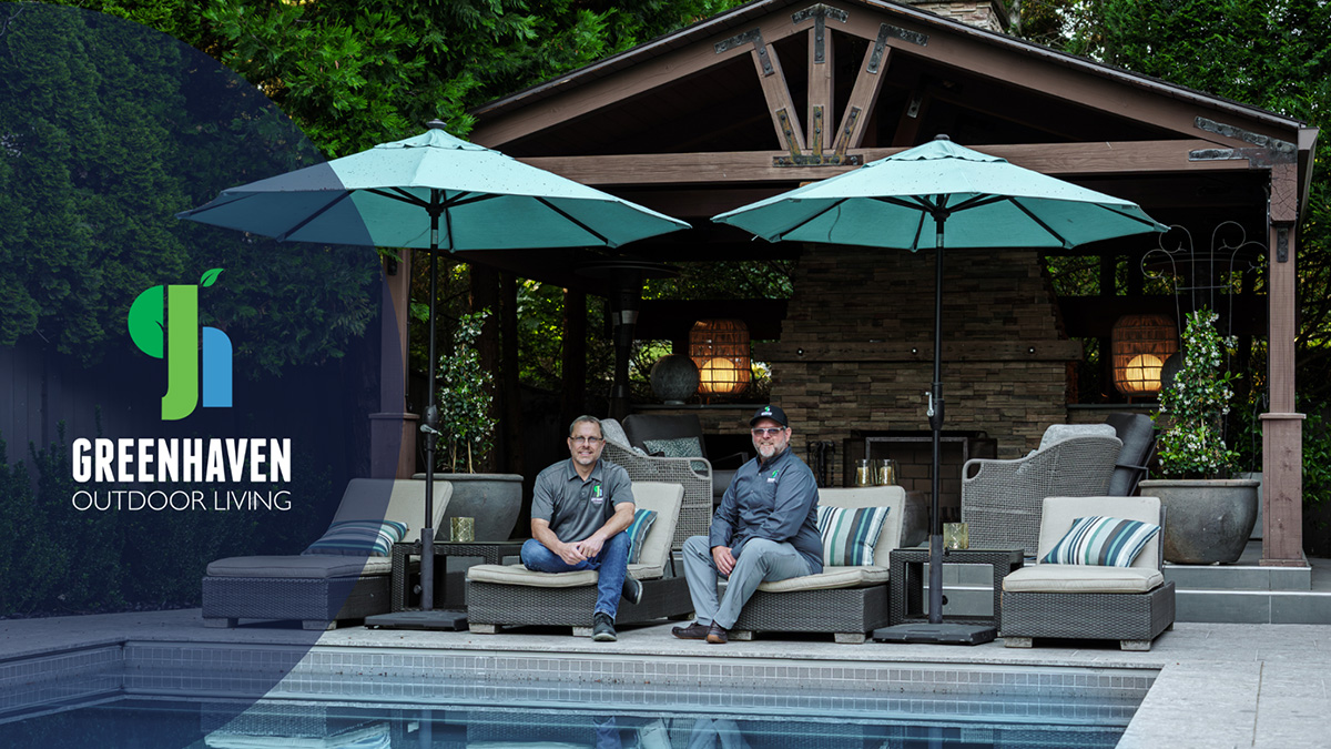 Rick Hooks and Eric McCuan of Greenhaven Outdoor Living sitting on loungers by a pool